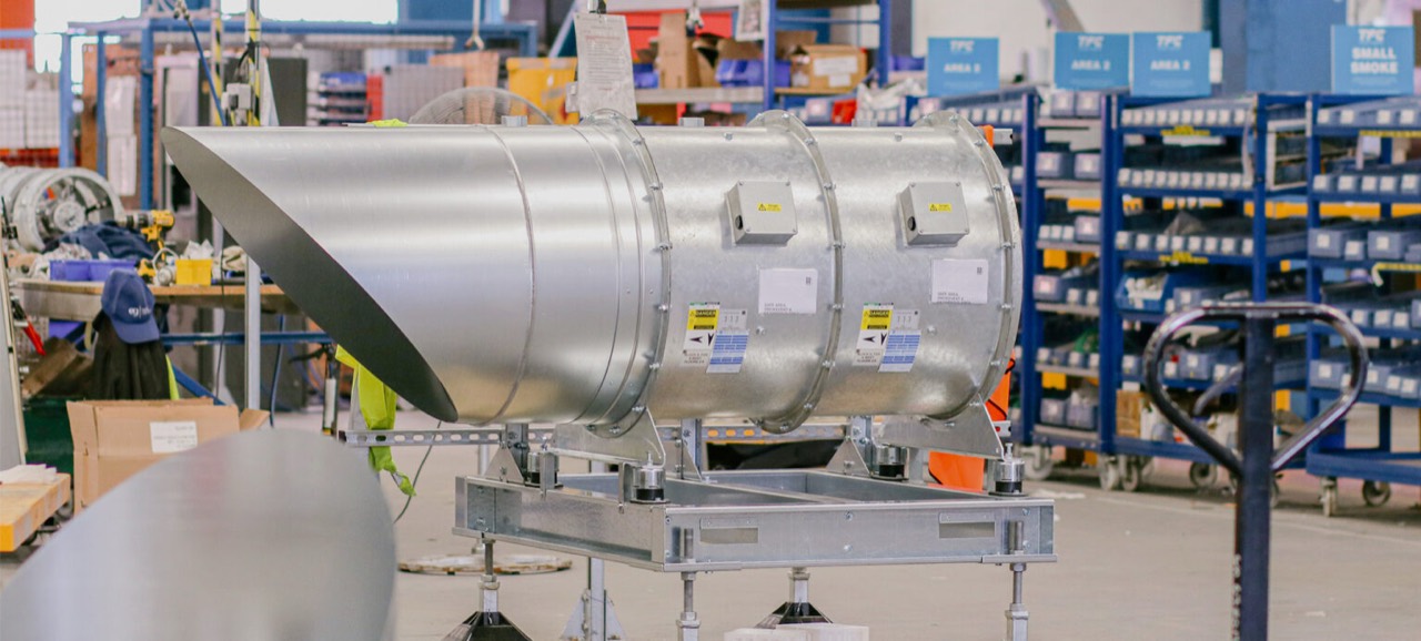 Large axial smoke-control fan assembly mounted on a steel support frame