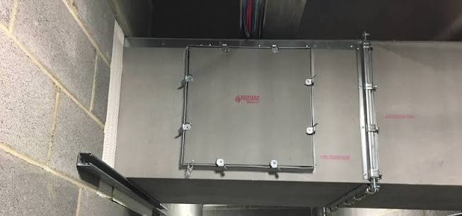 Installed fire-resisting ductwork access door with multiple retaining fasteners