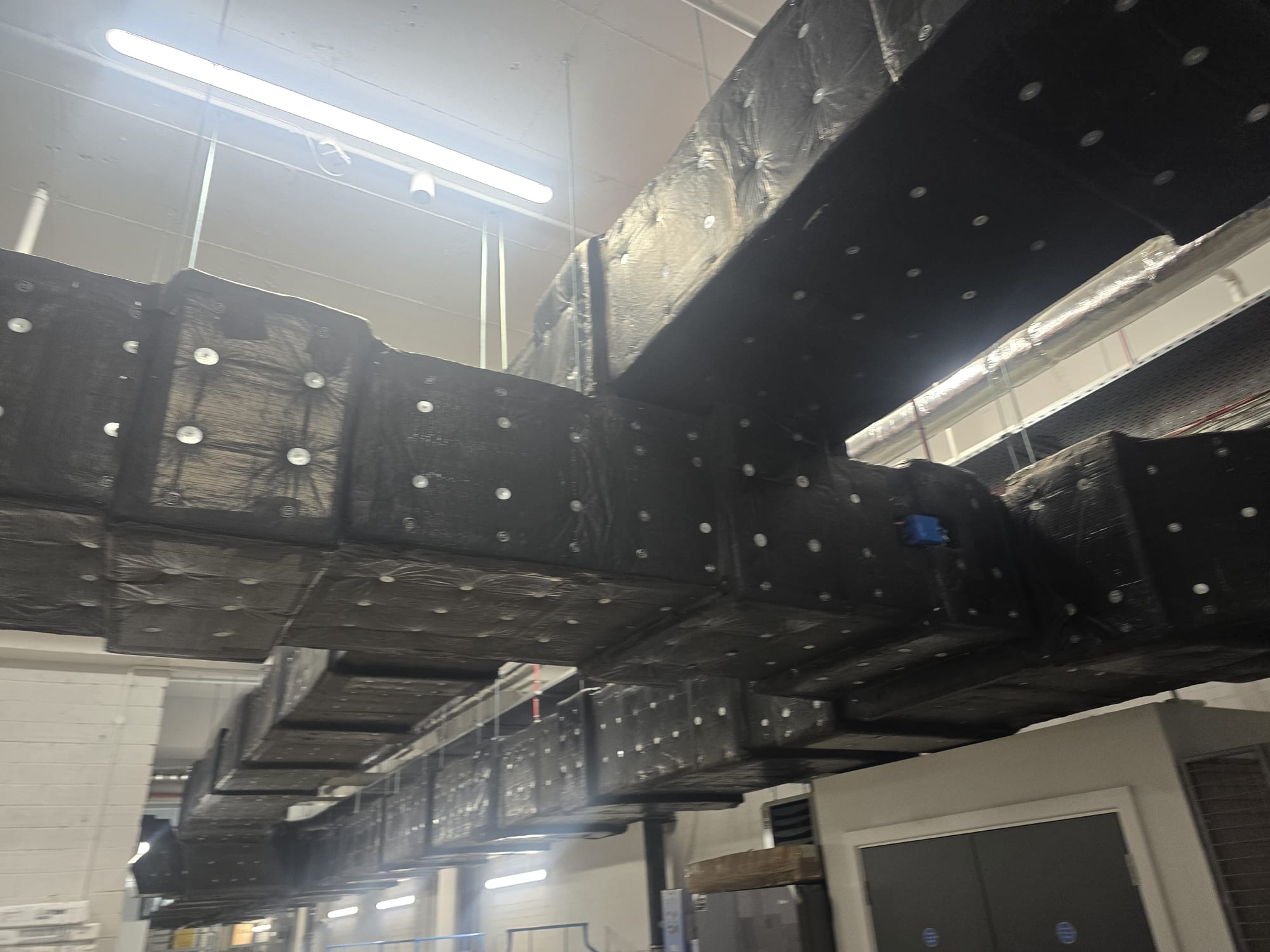Two-hour EN 1366-8 smoke extract ductwork protected with black-faced Isover U Protect